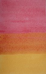 A Rose Madder wash overlapping an area of dry Raw Sienna